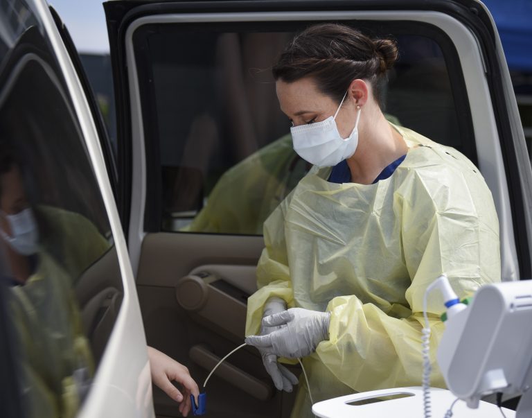 Image of Staff Sgt. Stephanie Laubach, a 96th Medical Group medical technician, takes a patient’s vital signs car-side